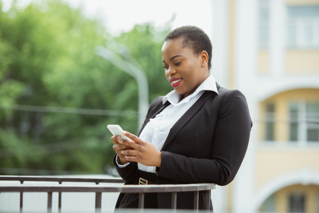 african-american-businesswoman-office-attire-smiling-looks-confident-happy-busy_155003-7456